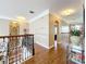 Hallway with hardwood flooring, decorative iron railing, and trim work at 4334 Tolkien St, Orlando, FL 32828