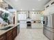 Modern kitchen with a large island, stainless steel appliances, and staircase views at 4334 Tolkien St, Orlando, FL 32828