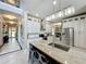 Open-concept kitchen featuring white cabinetry, granite countertops, and stainless steel appliances at 4334 Tolkien St, Orlando, FL 32828