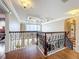 Upstairs landing featuring iron railings, hardwood floors, and a decorative ceiling at 4334 Tolkien St, Orlando, FL 32828