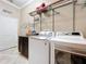 Laundry room with tile floors and a countertop with a washer and dryer at 4334 Tolkien St, Orlando, FL 32828