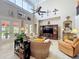 Spacious living room with high ceilings, tile floors, wooden entertainment center, and lots of art at 4334 Tolkien St, Orlando, FL 32828