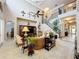 A grand living room with soaring ceilings, a staircase with wrought iron railings, and elegant decor at 4334 Tolkien St, Orlando, FL 32828