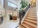 Open-concept living room with staircase, high ceilings, and plenty of natural light from large windows at 4334 Tolkien St, Orlando, FL 32828