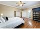 Spacious main bedroom with hardwood floors, a ceiling fan, and access to an ensuite bathroom at 4334 Tolkien St, Orlando, FL 32828