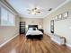Comfortable main bedroom featuring hardwood floors, a ceiling fan, and large windows at 4334 Tolkien St, Orlando, FL 32828
