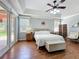 Inviting main bedroom with hardwood floors, tray ceiling, and sitting area near the windows at 4334 Tolkien St, Orlando, FL 32828
