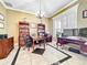 Home office with wooden furniture, built-in bookshelves, and tile floors at 4334 Tolkien St, Orlando, FL 32828