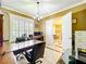 Bright office space, complete with wooden desk, tile floors, and natural light at 4334 Tolkien St, Orlando, FL 32828