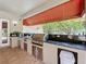 Outdoor kitchen featuring a stainless steel grill, dark countertops and convenient storage space at 4334 Tolkien St, Orlando, FL 32828