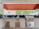 Outdoor kitchen featuring a grill and countertop area under a covered patio at 4334 Tolkien St, Orlando, FL 32828