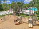 Playground featuring swings and slides with basketball court and swimming pool as backdrop at 4334 Tolkien St, Orlando, FL 32828