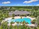 Aerial view of an inviting community pool with beach entry, waterfall feature, and manicured landscaping at 4334 Tolkien St, Orlando, FL 32828