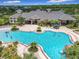A large community pool complex with ample lounge seating, a splash area, and lush landscaping at 4334 Tolkien St, Orlando, FL 32828