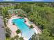 Aerial view of a large community pool area with wading pool, waterfall features and lush landscaping at 4334 Tolkien St, Orlando, FL 32828