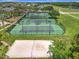 Aerial view of fenced in tennis and volleyball courts with lush landscaping at 4334 Tolkien St, Orlando, FL 32828
