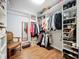 Bright walk-in closet with built-in shelving, wooden floors, and ample storage space for clothes and accessories at 4334 Tolkien St, Orlando, FL 32828