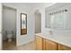Bright bathroom featuring white countertops, oak cabinets, and a walk-in shower at 4531 Se 30Th St, Ocala, FL 34480