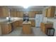 Spacious kitchen featuring wooden cabinets, granite countertops, stainless steel appliances, and a center island at 4531 Se 30Th St, Ocala, FL 34480
