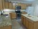 Bright, well-equipped kitchen with wooden cabinets, granite countertops, stainless steel appliances, and a center island at 4531 Se 30Th St, Ocala, FL 34480