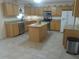 Bright kitchen with wooden cabinets, granite countertops, stainless steel appliances, and a center island at 4531 Se 30Th St, Ocala, FL 34480