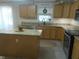 Well-lit kitchen featuring wooden cabinets, granite countertops, stainless steel appliances, and a central island at 4531 Se 30Th St, Ocala, FL 34480