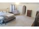 Spacious main bedroom showcasing a bed, sitting area, walk-in closet, and plush carpeting at 4531 Se 30Th St, Ocala, FL 34480