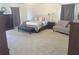 Bright main bedroom with a bed, sitting area, windows with curtains, and plush carpeting at 4531 Se 30Th St, Ocala, FL 34480