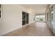 Large covered patio with tile floors and sliding glass doors to the outside space at 4531 Se 30Th St, Ocala, FL 34480