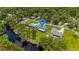 Aerial view of the house with a large backyard, trees, and water access indicated with a blue map pin at 5531 Marys Villa Rd, Groveland, FL 34736
