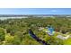 Aerial view of a home near a river and lake, surrounded by lush greenery and trees at 5531 Marys Villa Rd, Groveland, FL 34736