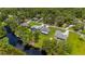 Aerial view of homes with landscaped yards, mature trees, and water access in a desirable neighborhood at 5531 Marys Villa Rd, Groveland, FL 34736