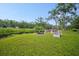 Spacious backyard featuring a fire pit and seating area, perfect for outdoor entertaining at 5531 Marys Villa Rd, Groveland, FL 34736