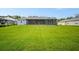 Large, grassy backyard featuring a screened-in porch area, perfect for outdoor enjoyment at 5531 Marys Villa Rd, Groveland, FL 34736