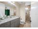 Bathroom features a granite countertop, with gray cabinets and a glass enclosed shower at 5531 Marys Villa Rd, Groveland, FL 34736
