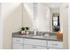 Close up of bathroom vanity with granite countertop, white cabinets and decor at 5531 Marys Villa Rd, Groveland, FL 34736