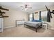 Spacious bedroom with plush carpet, ceiling fan, and a large window at 5531 Marys Villa Rd, Groveland, FL 34736