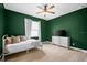 A stylish bedroom features a ceiling fan, light-colored floors, and a white dresser at 5531 Marys Villa Rd, Groveland, FL 34736