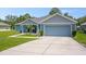 Attractive single-story home with a well-kept lawn, attached garage, and a quaint front patio at 5531 Marys Villa Rd, Groveland, FL 34736