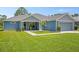 Inviting single-story home with a well-maintained lawn and a cozy front porch seating area at 5531 Marys Villa Rd, Groveland, FL 34736