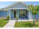 Inviting front porch with seating, complemented by lush landscaping and a charming entrance, perfect for relaxing at 5531 Marys Villa Rd, Groveland, FL 34736