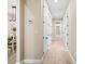 Hallway features wood floors, access to the dining area, and a bathroom at 5531 Marys Villa Rd, Groveland, FL 34736
