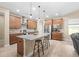 Modern kitchen boasts granite countertops, stainless appliances, island with seating, and wood floors at 5531 Marys Villa Rd, Groveland, FL 34736