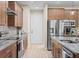 Kitchen features stainless steel appliances, granite countertops, and wood cabinets at 5531 Marys Villa Rd, Groveland, FL 34736
