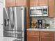 Close up of stainless refrigerator, microwave and granite counters in the kitchen at 5531 Marys Villa Rd, Groveland, FL 34736
