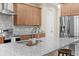 Well-equipped kitchen with granite counters, stainless appliances, and wood cabinets at 5531 Marys Villa Rd, Groveland, FL 34736