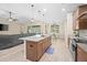 Open kitchen with granite counters, island seating, stainless appliances, and a dining area at 5531 Marys Villa Rd, Groveland, FL 34736