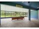 Screened-in back patio with comfortable seating overlooking a serene backyard with lush greenery and a large lake at 5531 Marys Villa Rd, Groveland, FL 34736