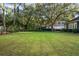 Large backyard featuring green grass, mature trees and partial view of the home at 6047 Blakeford Dr, Windermere, FL 34786