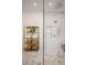 Modern shower with glass surround, tiled walls, and gold shelving unit at 6047 Blakeford Dr, Windermere, FL 34786